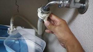 洗濯機用の蛇口からホースを引っ張る
